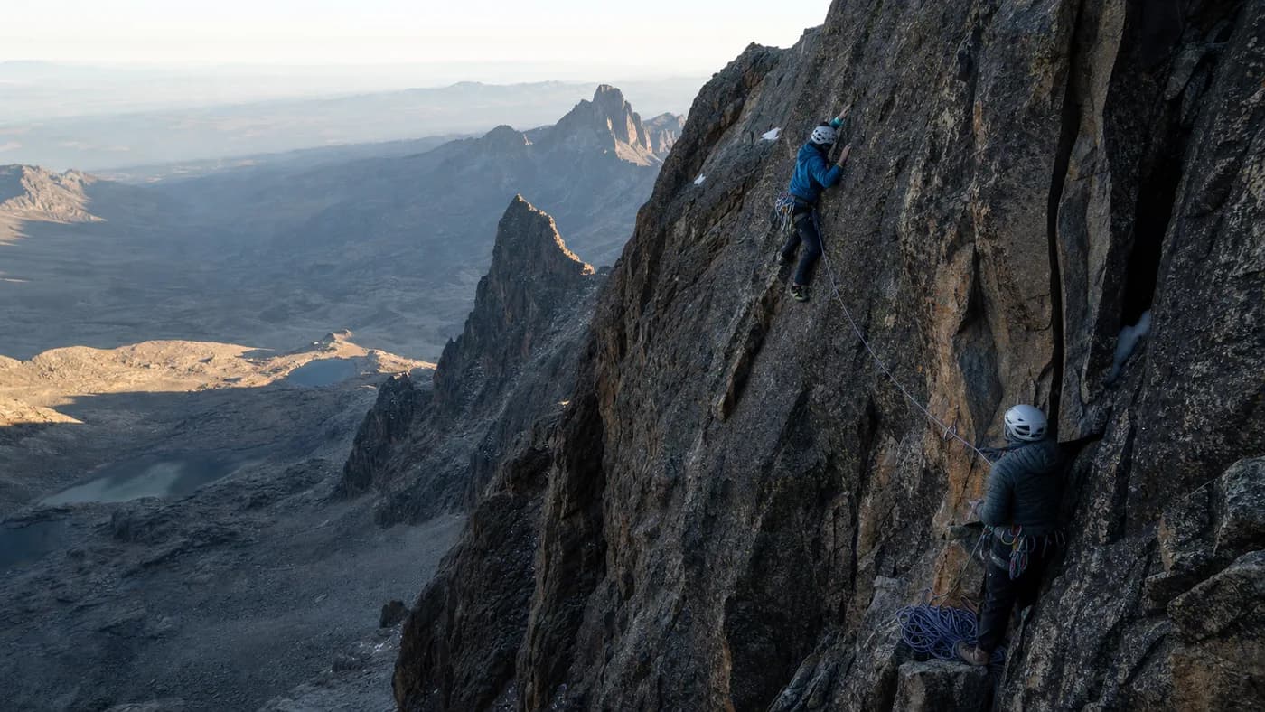 Generated editorial scene of roped climbers on high volcanic rock