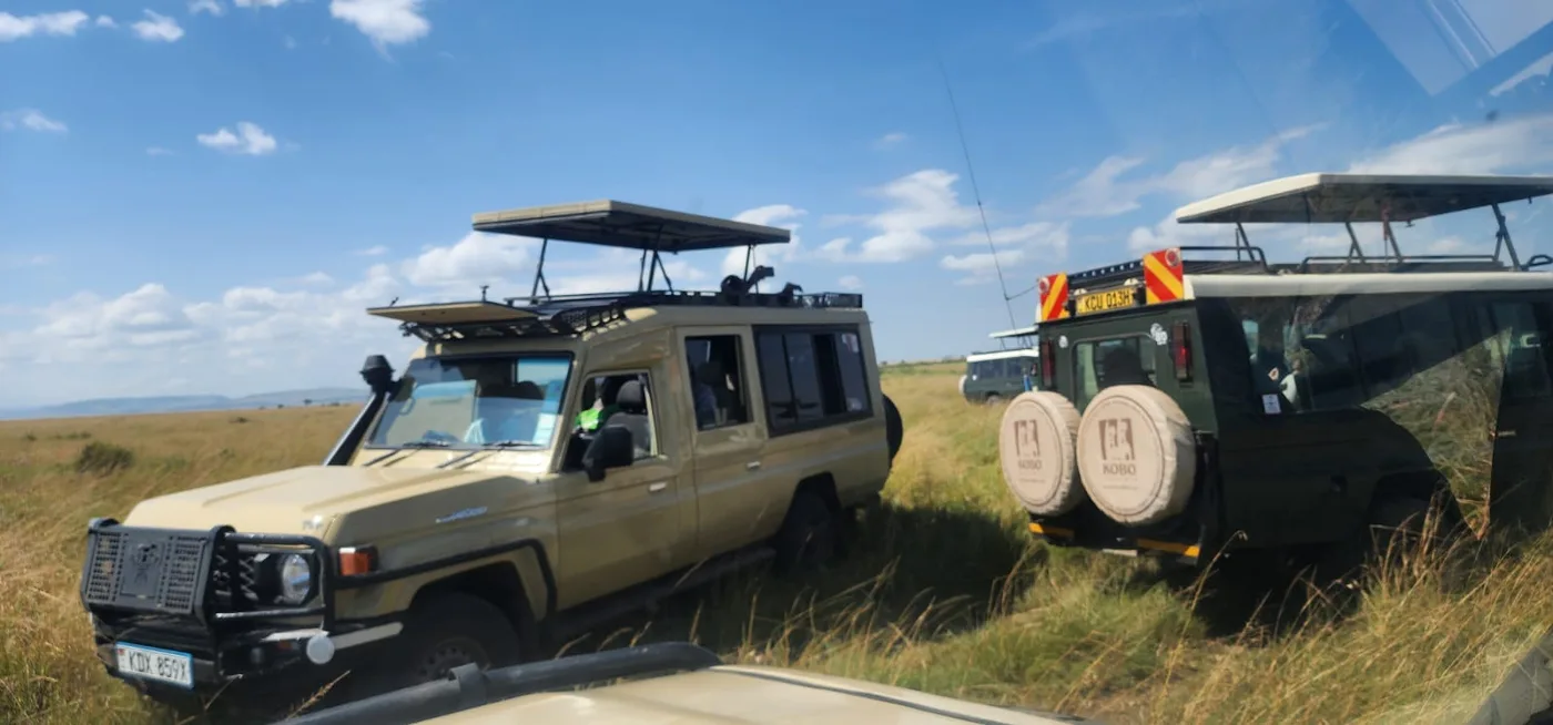 Two safari vehicles on an East African wildlife route